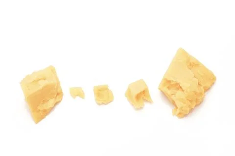 Broken Block of White Cheddar Cheese assorted chunks pieces bits Stock Photos