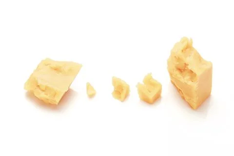Broken Block of White Cheddar Cheese assorted chunks pieces bits Stock Photos
