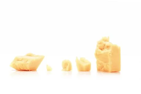 Broken Block of White Cheddar Cheese assorted chunks pieces bits Stock Photos