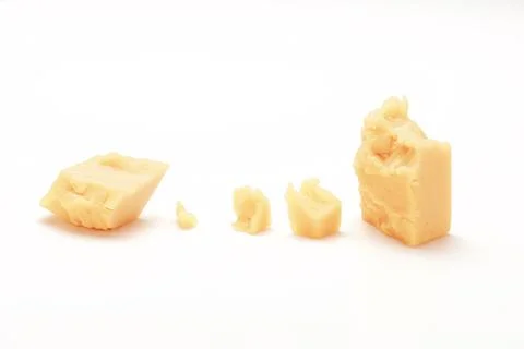 Broken Block of White Cheddar Cheese assorted chunks pieces bits Stock Photos