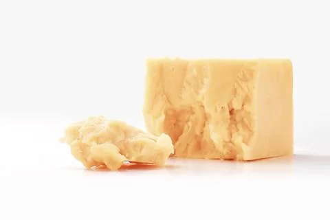 Broken Block of White Cheddar Cheese assorted chunks pieces bits Stock Photos