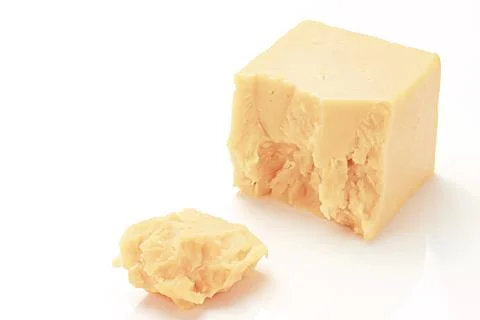 Broken Block of White Cheddar Cheese assorted chunks pieces bits Stock Photos