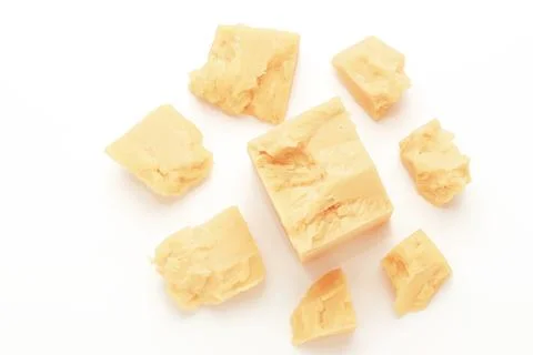 Broken Block of White Cheddar Cheese assorted chunks pieces bits Stock Photos