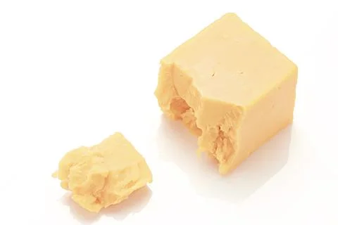 Broken Block of White Cheddar Cheese assorted chunks pieces bits Stock Photos
