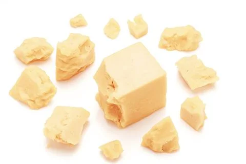 Broken Block of White Cheddar Cheese assorted chunks pieces bits Stock Photos