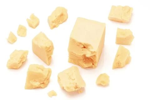 Broken Block of White Cheddar Cheese assorted chunks pieces bits Stock Photos