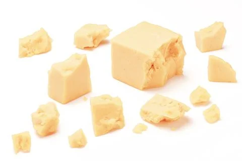 Broken Block of White Cheddar Cheese assorted chunks pieces bits Stock Photos
