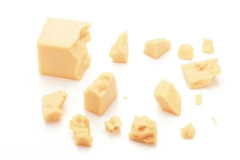 Broken Block of White Cheddar Cheese assorted chunks pieces bits Stock Photos