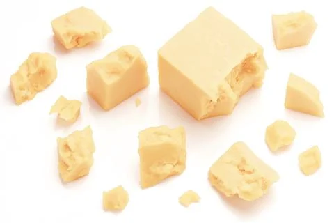 Broken Block of White Cheddar Cheese assorted chunks pieces bits Stock Photos