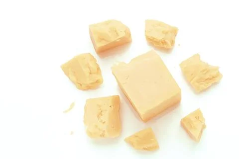 Broken Block of White Cheddar Cheese assorted chunks pieces bits Stock Photos