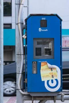 Broken blue box for automatic payment of public bicycle rents Stock Photos