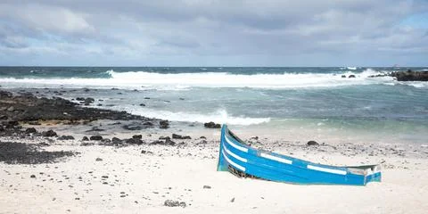 Broken boat on a beach Stock Photos