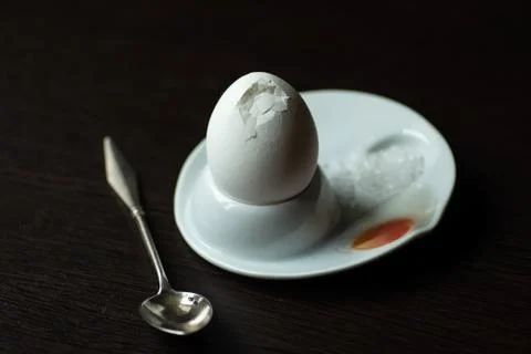 Broken boiled egg with spoon, stand and salt Stock Photos