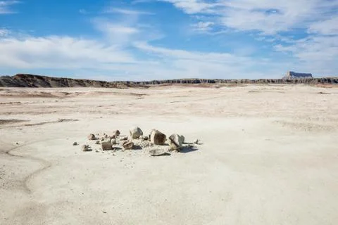 Broken boulder in smooth flat desert plain Stock Photos