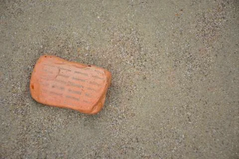 A broken brick on the beach Stock-Fotos