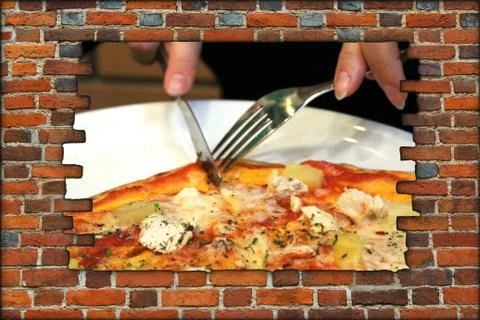 Broken brick wall and fork knife and tasty pizza Stock Photos