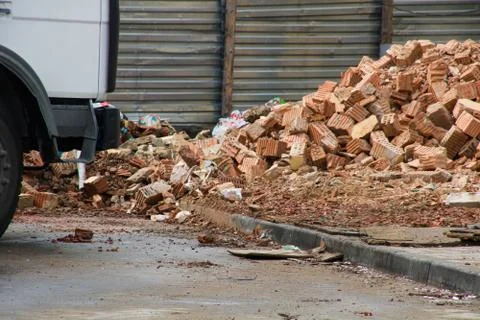 Broken bricks at construction site and car 스톡 사진