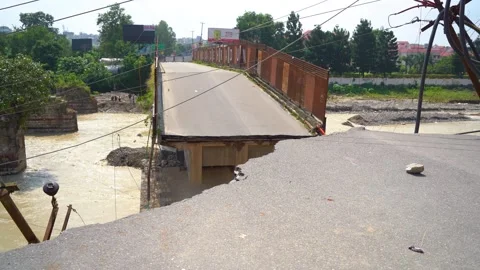 Broken bridge and washed out road in Dehradun India Stock Footage 321041011