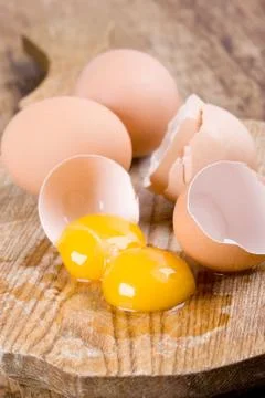 Broken brown eggs Stock Photos