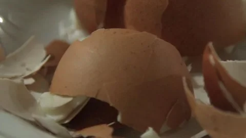 Broken brown eggshells on plate macro close up Stock Footage 326440453