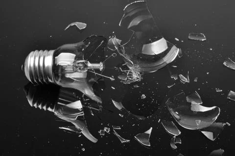 Broken bulb on black background Stock Photos