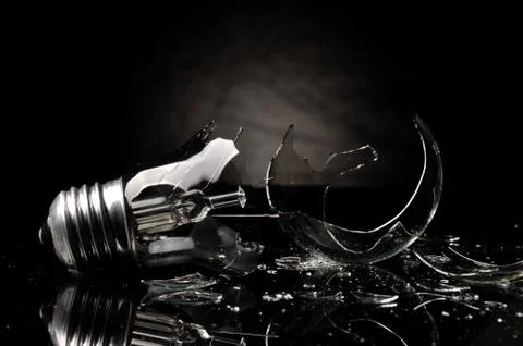 Broken bulb on black background Stock Photos