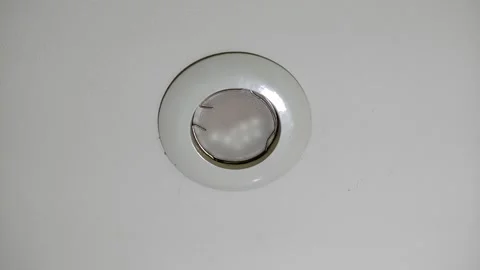 Broken, burnt out LED light bulb flickering on the ceiling	 Video stock 320017621
