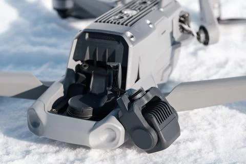 Broken camera and drone arm after crash on snow in winter Stock Photos