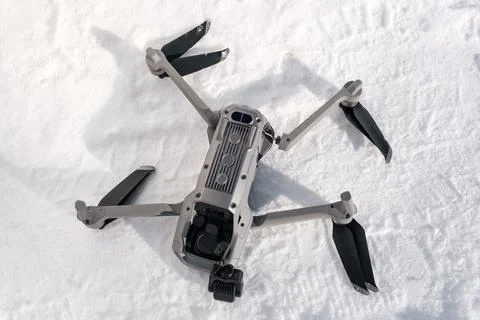 Broken camera and drone arm after crash on snow in winter Stock Photos