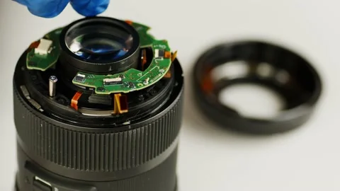 Broken camera lens. Close up. Unrecognizable person in gloves unscrews bolt with Stock Footage 190786766