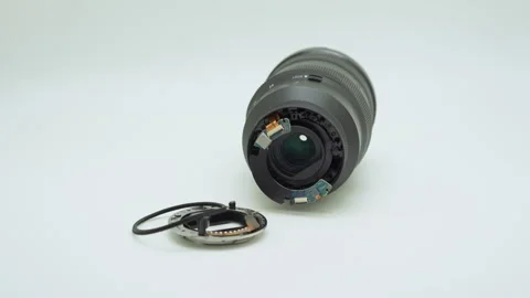 Broken camera lens with detached bayonet mount on white background. Stock Footage 313660698