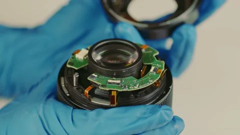 Broken camera lens in hands of master. Close up. Stock Footage 181233228