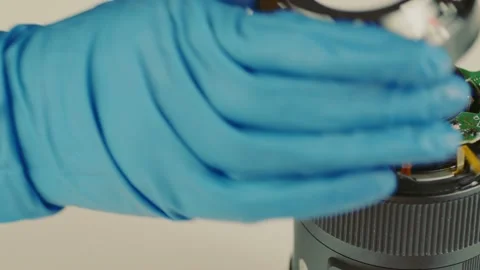 Broken camera lens in hands of master. Close up. Unrecognizable person in gloves Stock Footage 181959638