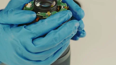 Broken camera lens in hands of master. Close up. Unrecognizable person in gloves Stock Footage 183945392