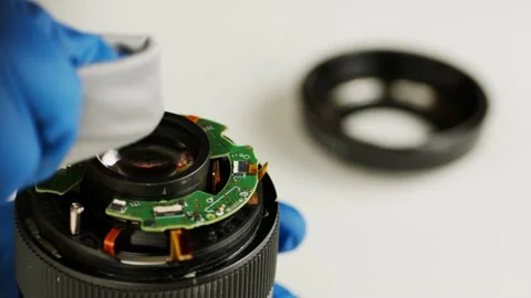 Broken camera lens in hands of master. Unrecognizable person in gloves cleaning Stock Footage 183947182