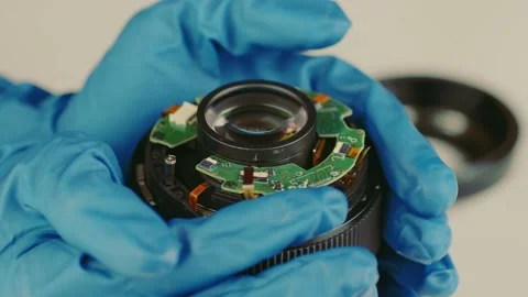 Broken camera lens in hands of master. Close up. Unrecognizable person in gloves Stock Footage 186110395