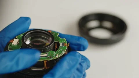 Broken camera lens in hands of master. Close up. Unrecognizable person in gloves Stock Footage 187130077