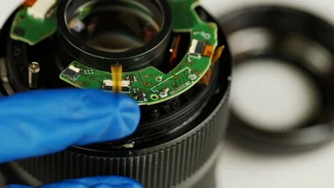 Broken camera lens in hands of master. Close up. Unrecognizable person in gloves Stock Footage 187425348