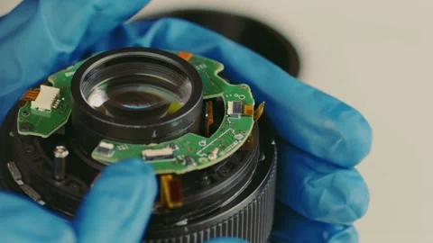 Broken camera lens in hands of master. Close up. Unrecognizable person in gloves Stock Footage 188254332
