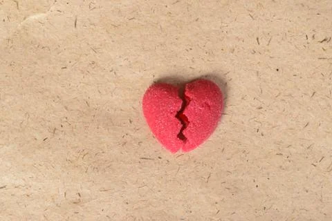Broken candy heart on paper Stock Photos