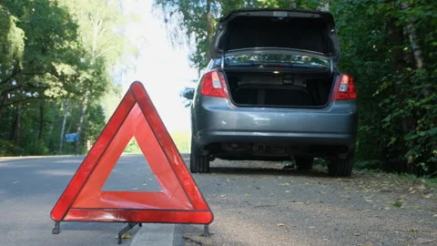 Broken car in the forest. Red triangle as emergency stop sign.  Stock Footage 137604645