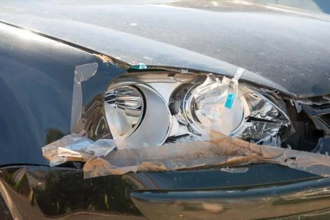 Broken car headlight, grey car Stock Photos