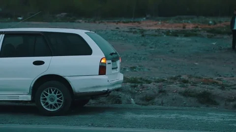 Broken car on the roadside in the evening Stock Footage 76000184