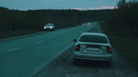 Broken car on the roadside in the evening Stock Footage 76000292