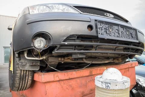 Broken car in trash Stock Photos