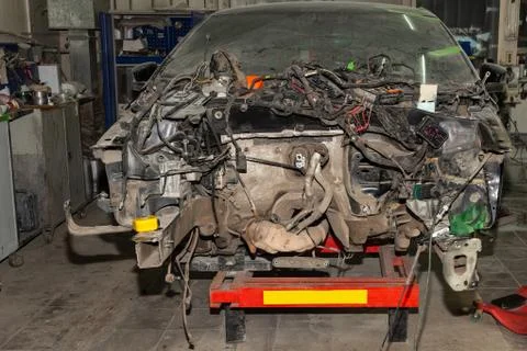 A broken car with a violation of geometry is on the stocks for leveling and r Stock Photos