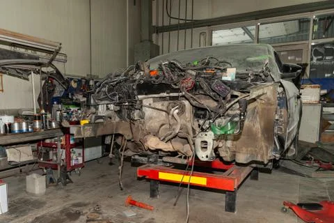 A broken car with a violation of geometry is on the stocks for leveling and r Stock Photos