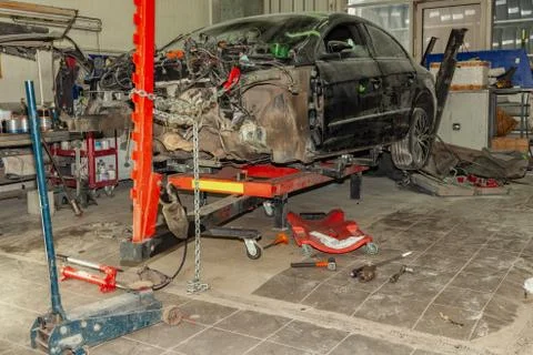 A broken car with a violation of geometry is on the stocks for leveling and r Stock Photos
