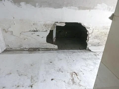 Broken Ceiling panels damaged with huge hole on dirty old room Stock Photos