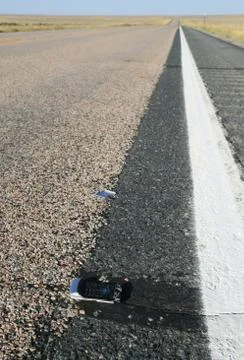 Broken cell phone on road side Stock Photos